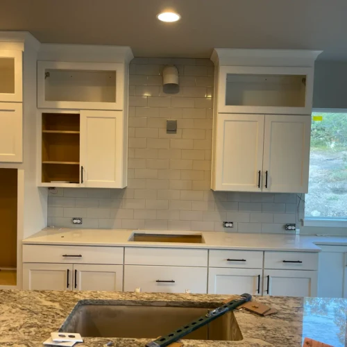 Kitchen featuring a neutral beige-grey subway tile backsplash laid in a traditional running bond pattern in Colorado Springs, CO, by XCEL TILE.