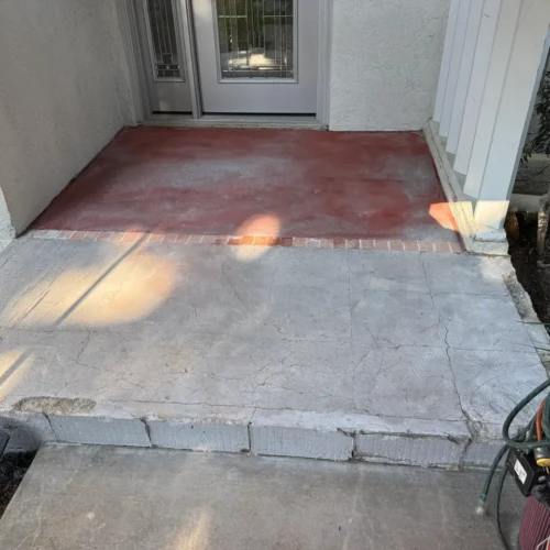 Concrete front porch foundation showing surface preparation and repairs prior to exterior tile installation in The Broadmoor, CO, by XCEL TILE.