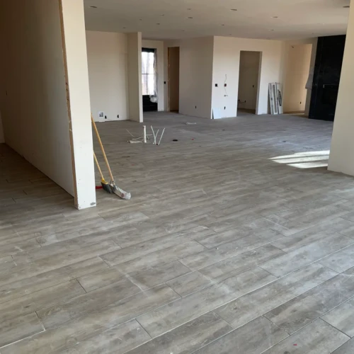 Wide open-concept floor tile installation by XCEL TILE, featuring staggered wood-look planks in a Parker, Colorado residence.