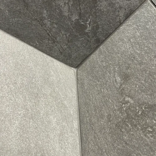 Macro close-up of a flawless inside corner tile grout joint on dark stone-look porcelain walls in Black Forest, CO, by XCEL TILE.