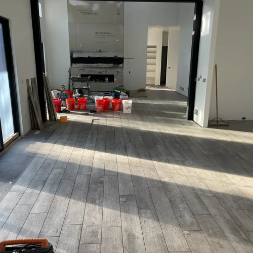 Sunlit luxury living room in Black Forest, CO, featuring completed wood-look porcelain tile flooring installation by XCEL TILE.